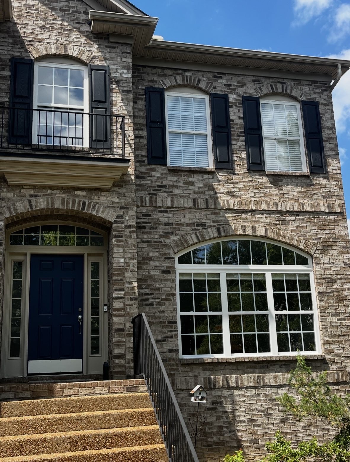 Crystal-clear arched and shuttered windows on a Knoxville brick home